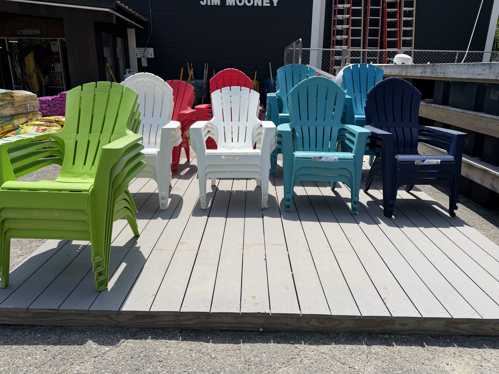 Colorful Adirondack chairs stacked on the display deck