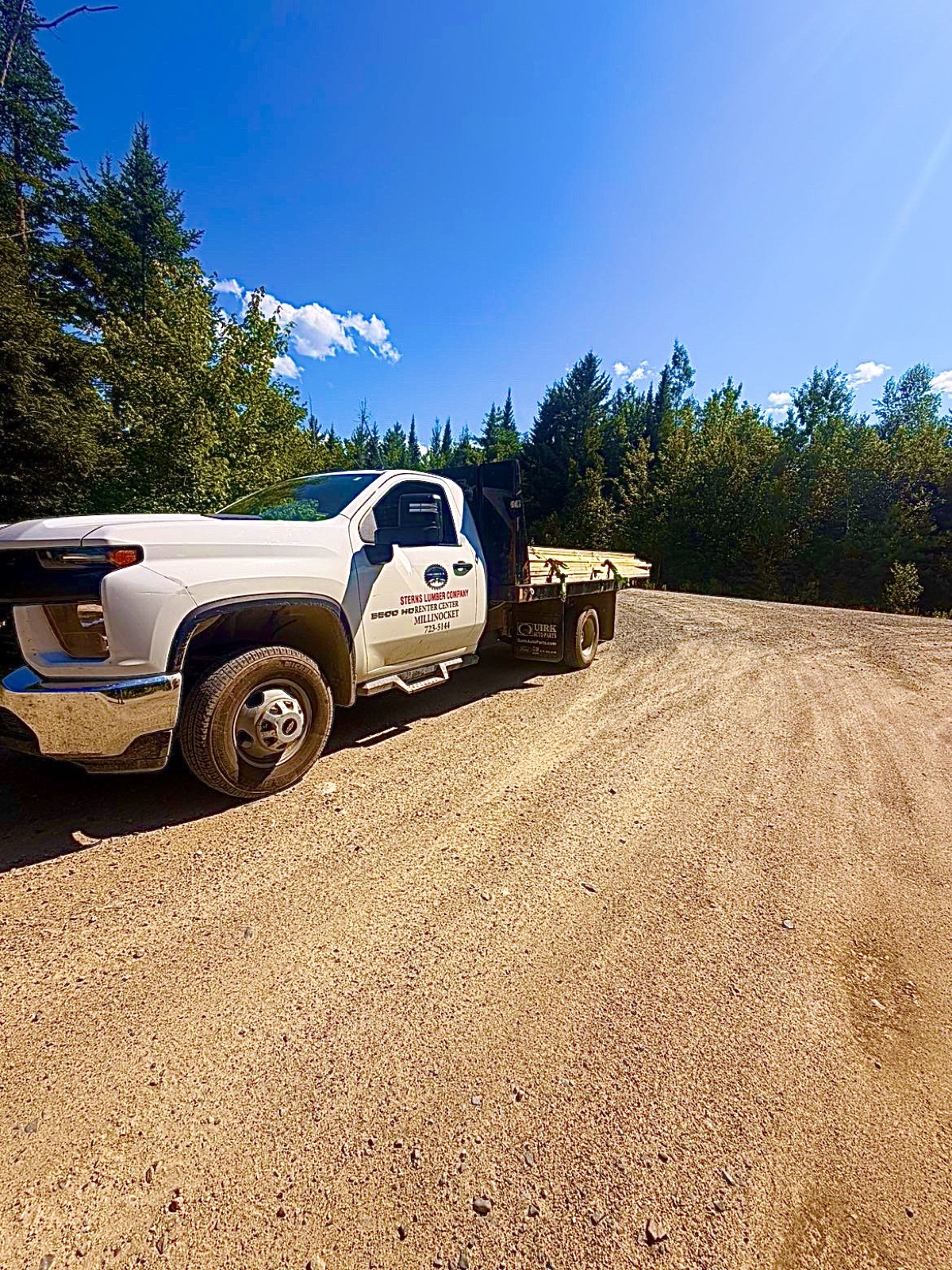 Sterns Lumber delivery flatbed loaded with lumber on a jobsite road